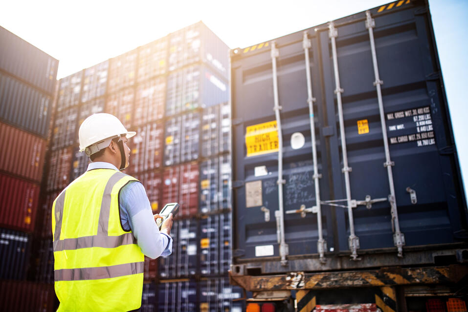 Workers in front of transport containers